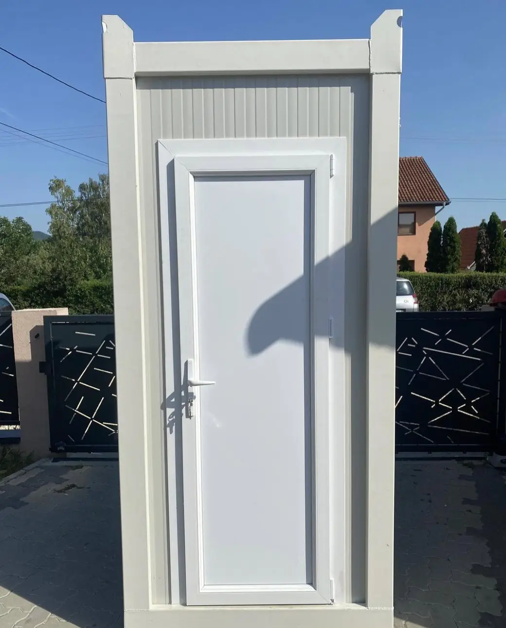 White single-stall flushing restroom cabin with a paneled door